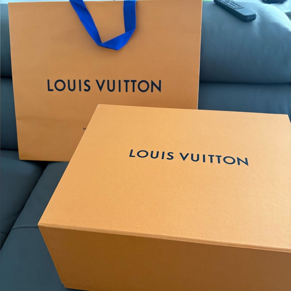 Louis Vuitton bag and box with envelope and ribbon.